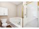 Bright bathroom featuring a soaking tub with tiled backsplash, a glass door shower, and modern fixtures at 6033 Trailhead Rd, Highlands Ranch, CO 80130
