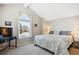 Comfortable bedroom with large window, vaulted ceilings, and soft neutral colors at 6033 Trailhead Rd, Highlands Ranch, CO 80130