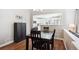 Charming dining area with dark wood table and chairs, seamlessly connects to a bright, white kitchen at 6033 Trailhead Rd, Highlands Ranch, CO 80130