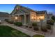 Charming home features stone accents, well-maintained landscaping, and a cozy front porch at 6033 Trailhead Rd, Highlands Ranch, CO 80130