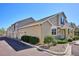Home exterior featuring attached garage, manicured landscaping, and covered front entrance at 6033 Trailhead Rd, Highlands Ranch, CO 80130