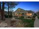 Attractive exterior with covered porch, manicured landscaping, and tree-lined street at 6033 Trailhead Rd, Highlands Ranch, CO 80130