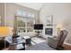 Bright living room features a fireplace, large windows, and comfortable seating at 6033 Trailhead Rd, Highlands Ranch, CO 80130