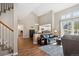 Open concept living area with modern staircase, hardwood floors, and natural light at 6033 Trailhead Rd, Highlands Ranch, CO 80130