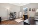 Bright home office with large window, featuring multiple work spaces, desk, and comfortable seating at 6033 Trailhead Rd, Highlands Ranch, CO 80130