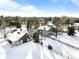 Aerial view of a large property showcasing the home, outbuildings, and surrounding snowy landscape at 50 Meade Ln, Cherry Hills Village, CO 80113