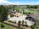 Stunning aerial view of the property showcasing the landscaping, multiple garages, and circular driveway at 50 Meade Ln, Cherry Hills Village, CO 80113