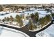 Aerial view of a large estate surrounded by trees and snow-covered landscape at 50 Meade Ln, Cherry Hills Village, CO 80113