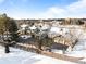 An aerial view of a large house with a long driveway and multiple garages at 50 Meade Ln, Cherry Hills Village, CO 80113