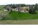 Aerial view showcasing the expansive fenced backyard, well-manicured lawn, and outdoor patio area at 50 Meade Ln, Cherry Hills Village, CO 80113