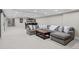 Spacious basement features a wet bar and an oversized sectional with throw pillows at 50 Meade Ln, Cherry Hills Village, CO 80113