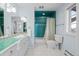 Unique bathroom with teal shower, light blue walls, and white tile at 50 Meade Ln, Cherry Hills Village, CO 80113