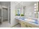 Bathroom with a tiled counter and hollywood style lights surrounding the mirror at 50 Meade Ln, Cherry Hills Village, CO 80113