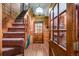 Wood paneled entryway features wood floors, stairs to the left, and wood framed door at 50 Meade Ln, Cherry Hills Village, CO 80113