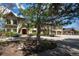 Beautiful home with a manicured lawn, mature trees, and a circular driveway providing curb appeal at 50 Meade Ln, Cherry Hills Village, CO 80113