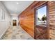Hallway with wooden walls and tiled floors at 50 Meade Ln, Cherry Hills Village, CO 80113