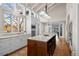 Bright, modern kitchen featuring an island, granite countertops, and hardwood floors at 50 Meade Ln, Cherry Hills Village, CO 80113