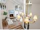 Open-concept living room with fireplace, chandelier, and large windows at 50 Meade Ln, Cherry Hills Village, CO 80113