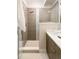 Modern bathroom with a walk-in shower and double vanity at 1822 Grove St # 110, Denver, CO 80204