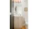 Clean bathroom with light wood vanity, toilet and large mirror at 1822 Grove St # 110, Denver, CO 80204