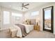 Spacious bedroom with a king-size bed and access to a balcony at 1822 Grove St # 110, Denver, CO 80204