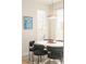 Stylish dining area with round table and chairs, framed art, and a window with blinds at 1822 Grove St # 110, Denver, CO 80204