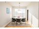 Modern dining area featuring a round table, six chairs, and a large window at 1822 Grove St # 110, Denver, CO 80204