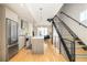 Modern kitchen with island, stainless steel appliances, and hardwood floors at 1822 Grove St # 110, Denver, CO 80204