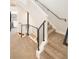 Modern staircase with metal railing and carpeted steps at 1822 Grove St # 110, Denver, CO 80204