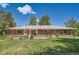 The house has raised garden beds, and the backyard offers plenty of space for activities at 305 Cottonwood Ct, Longmont, CO 80501
