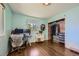 This bedroom features hardwood floors, a closet, and a large window at 305 Cottonwood Ct, Longmont, CO 80501