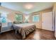Serene bedroom with hardwood floors, soft lighting, and a comfortable bed, providing a relaxing retreat at 305 Cottonwood Ct, Longmont, CO 80501