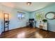 This bedroom has hardwood floors, two windows, and a small storage unit at 305 Cottonwood Ct, Longmont, CO 80501