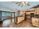 Open kitchen featuring stainless steel appliances, light wood cabinets, and a seamless flow to the living area at 305 Cottonwood Ct, Longmont, CO 80501