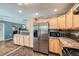 Spacious kitchen with modern stainless steel appliances, light wood cabinetry, and an open layout at 305 Cottonwood Ct, Longmont, CO 80501