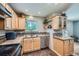 Bright kitchen with light wood cabinetry, stainless steel appliances, and decorative backsplash at 305 Cottonwood Ct, Longmont, CO 80501