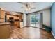 Open-concept kitchen flowing into a dining area, featuring light wood cabinetry and stainless steel appliances at 305 Cottonwood Ct, Longmont, CO 80501