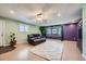 Spacious living room featuring plush carpeting, large windows, and a comfortable leather sofa for Gathering gatherings at 305 Cottonwood Ct, Longmont, CO 80501