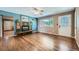 Warm living room with hardwood floors, a cozy fireplace, and a bright front door at 305 Cottonwood Ct, Longmont, CO 80501