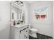 Bright bathroom featuring a modern vanity with black hardware and stylish black tile flooring at 1858 S Lincoln St, Denver, CO 80210
