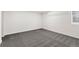 This bedroom features neutral paint, grey carpet, and natural light at 1858 S Lincoln St, Denver, CO 80210