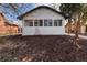 Exterior of white painted brick home with dark trim and a bright sunroom at 1858 S Lincoln St, Denver, CO 80210