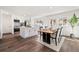Spacious kitchen with white cabinetry, stainless steel appliances, kitchen island, and adjoining dining area at 1858 S Lincoln St, Denver, CO 80210