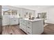 Kitchen island featuring a white countertop and cabinetry with black hardware at 1858 S Lincoln St, Denver, CO 80210