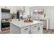 Bright kitchen features a center island, stainless steel appliances, and decorative tile backsplash at 1858 S Lincoln St, Denver, CO 80210