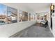 Enclosed sunroom with white brick walls and several windows overlooking the front yard at 1858 S Lincoln St, Denver, CO 80210