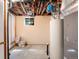 Utility space in the basement showing a water heater and exposed plumbing, along with a toilet at 2698 S Niagara St, Denver, CO 80224
