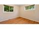 Cozy bedroom with hardwood floors, two windows, and neutral walls, creating a serene retreat at 2698 S Niagara St, Denver, CO 80224