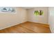 A bright bedroom featuring hardwood floors, neutral walls, and window with lush green views at 2698 S Niagara St, Denver, CO 80224