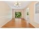 Bright dining room with hardwood floors, a modern chandelier and sliding door to outside at 2698 S Niagara St, Denver, CO 80224